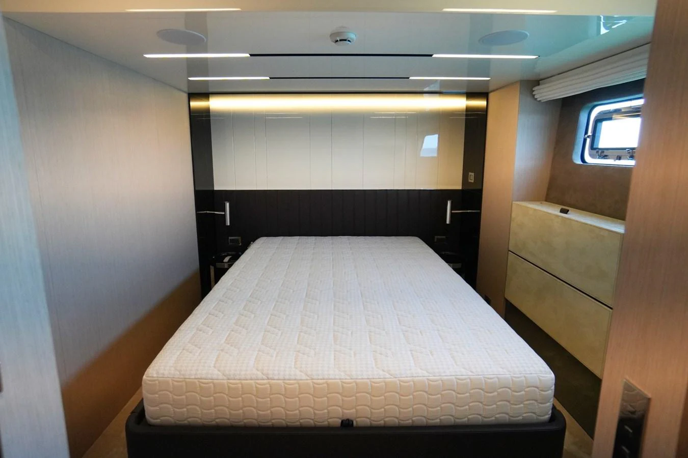 The stateroom features a comfortable bed with modern lighting and ample storage. aboard AMY Yacht for Sale
