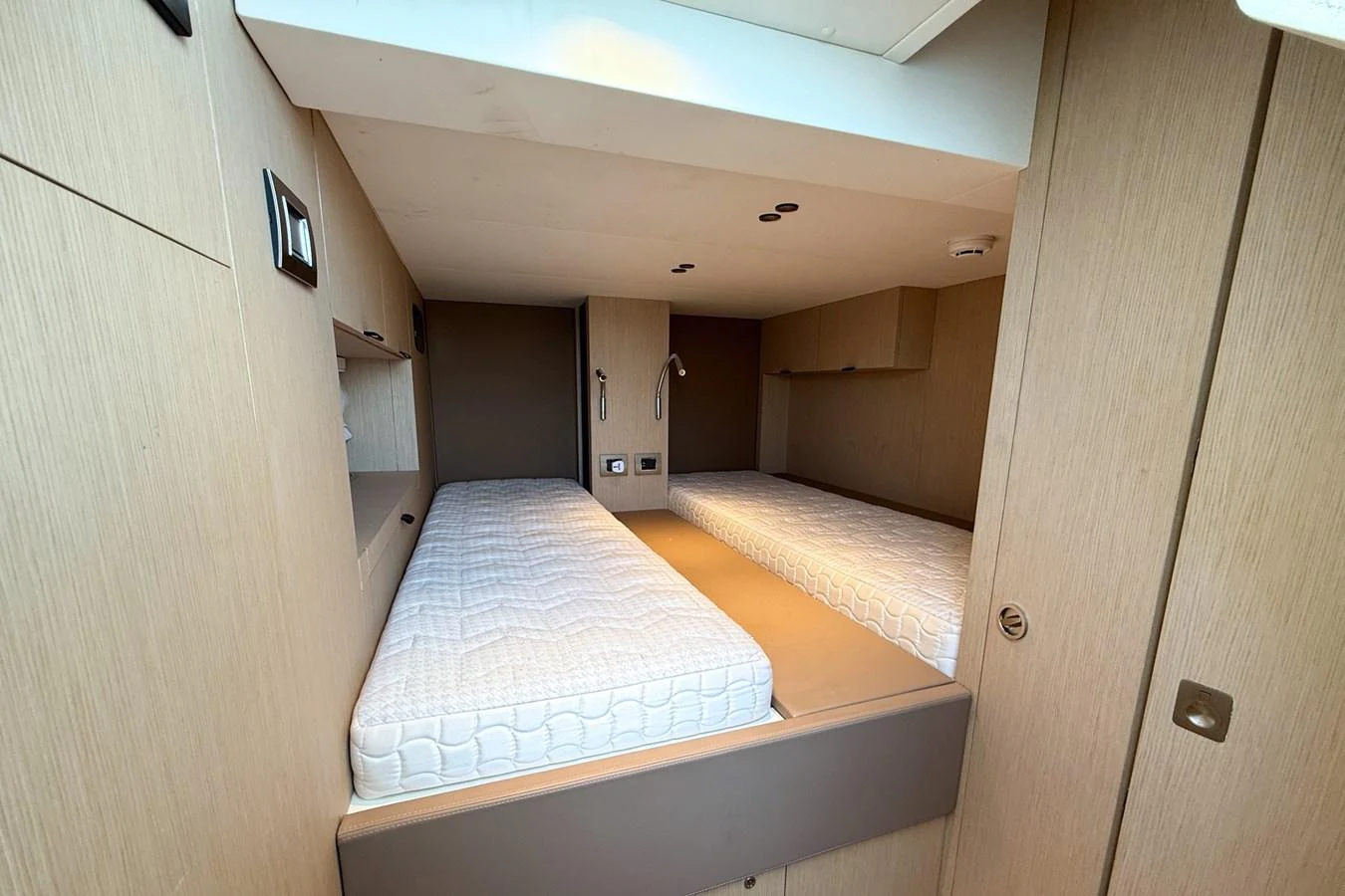 The twin cabin features two single beds with a modern, minimalist design. aboard AMY Yacht for Sale