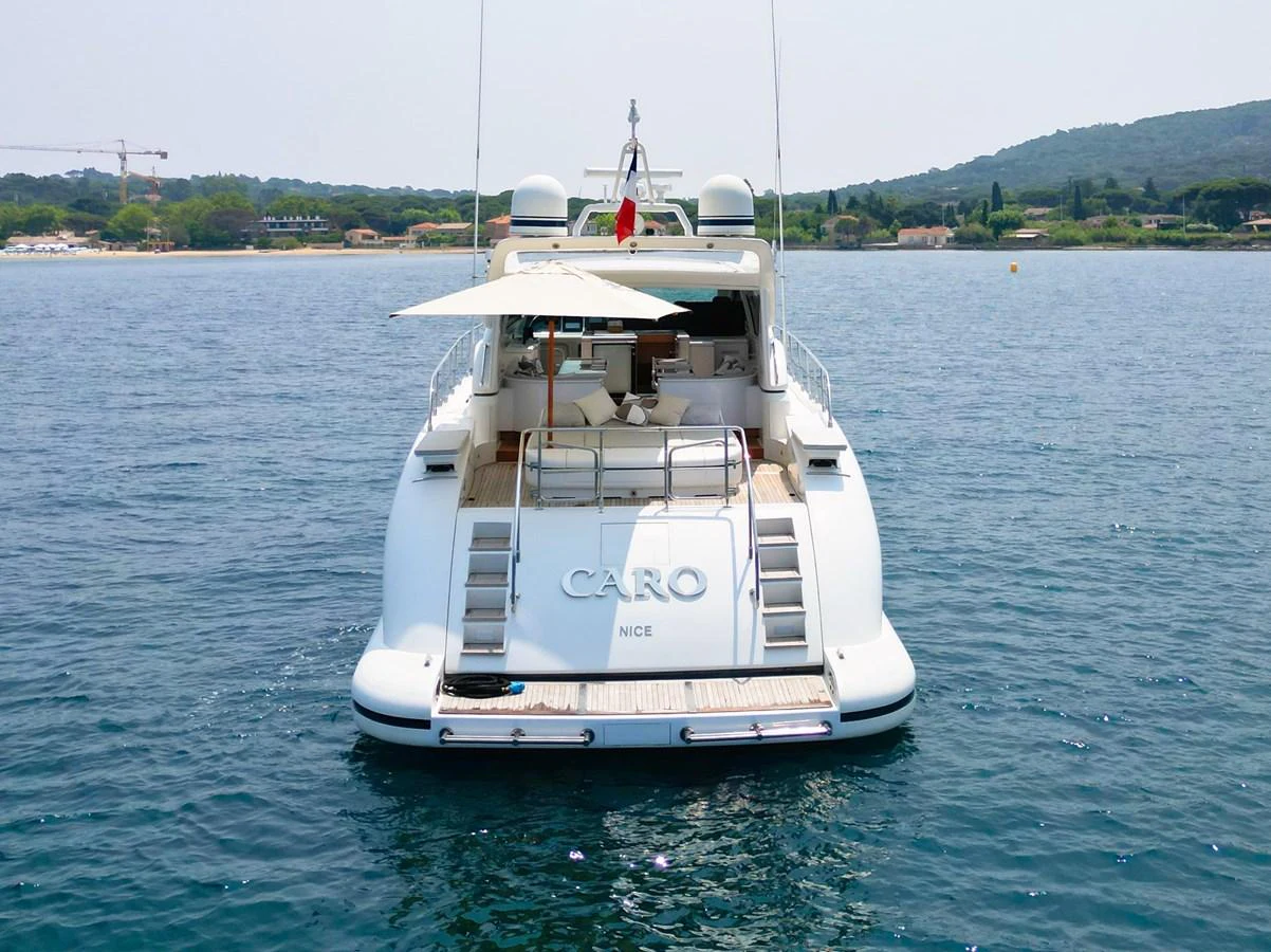 The yacht's aft deck offers a welcoming space with a shaded seating area, perfect for relaxation on the water. aboard CARO Yacht for Sale