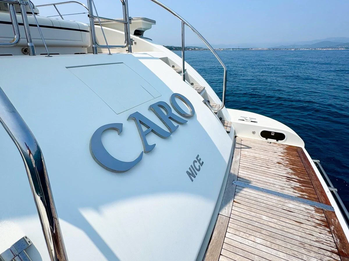 The aft deck of the yacht features a spacious and inviting area with a view of the serene sea. aboard CARO Yacht for Sale