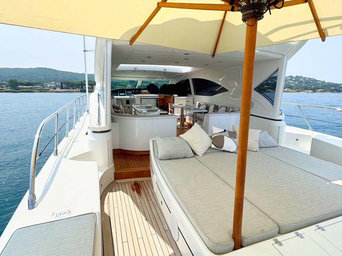 The aft deck features a spacious lounging area with comfortable seating and a shaded canopy. aboard CARO Yacht for Sale