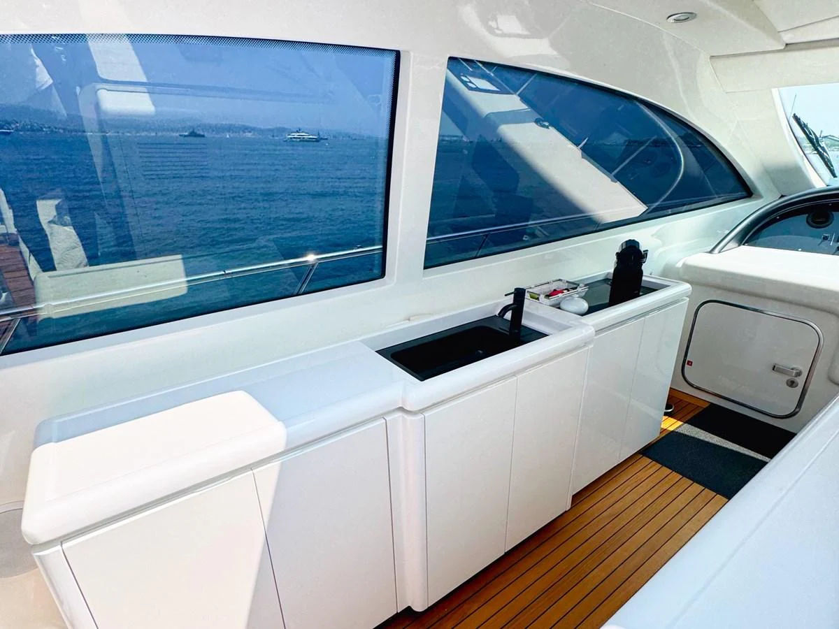 The sleek galley area offers a modern and functional space with a view of the sea. aboard CARO Yacht for Sale