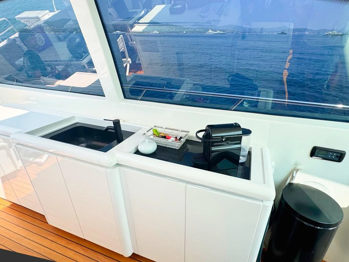 A sleek galley area with modern appliances and a view of the sea. aboard CARO Yacht for Sale