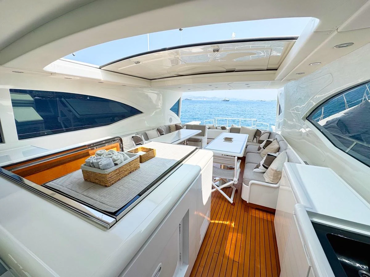 The aft deck offers a spacious and elegant outdoor seating area with a stunning view of the sea. aboard CARO Yacht for Sale