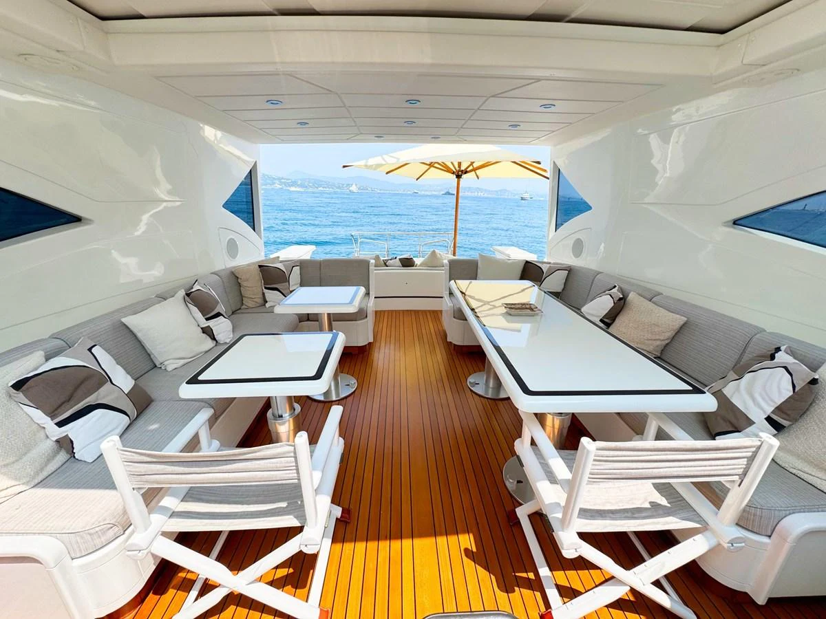 The aft deck features comfortable seating and dining areas with a stunning ocean view. aboard CARO Yacht for Sale