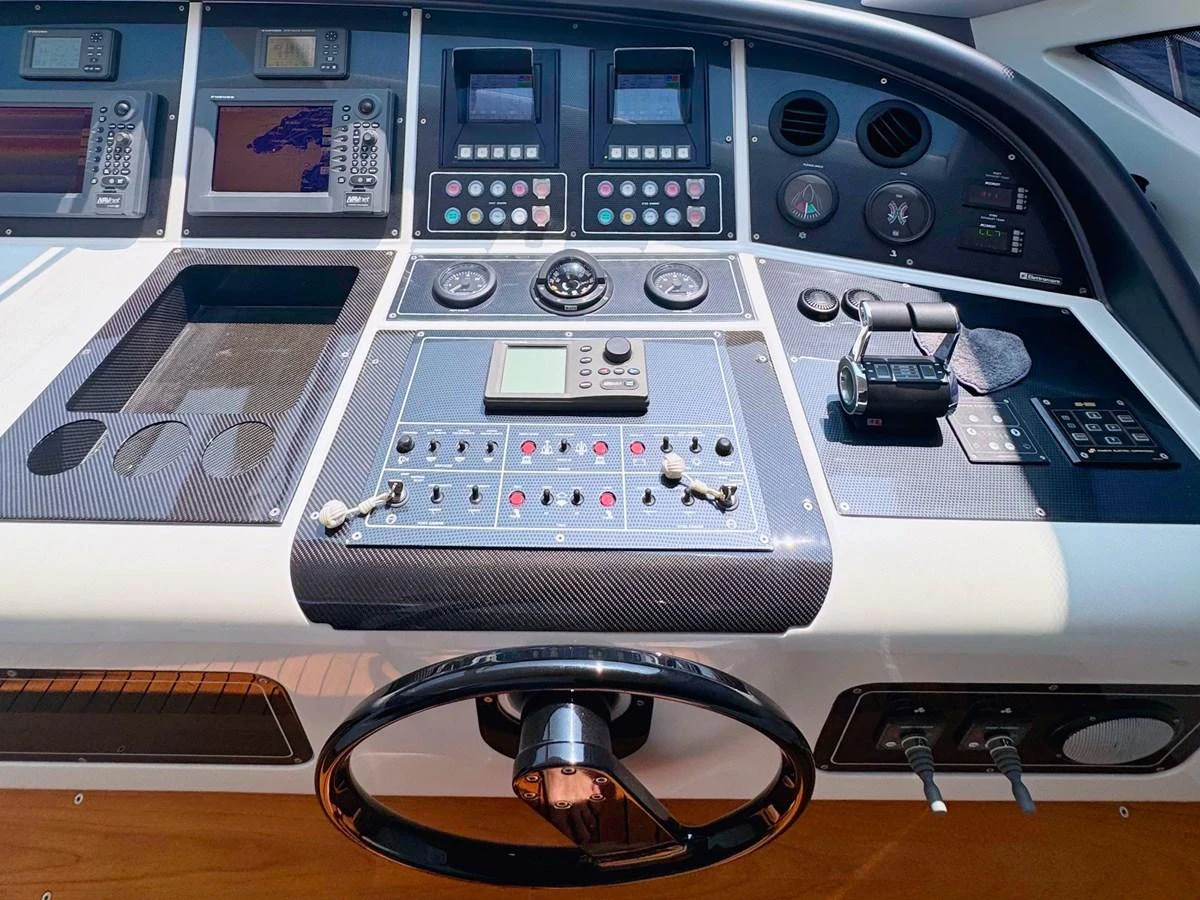 The helm station features advanced navigation and control systems for precise yacht handling. aboard CARO Yacht for Sale