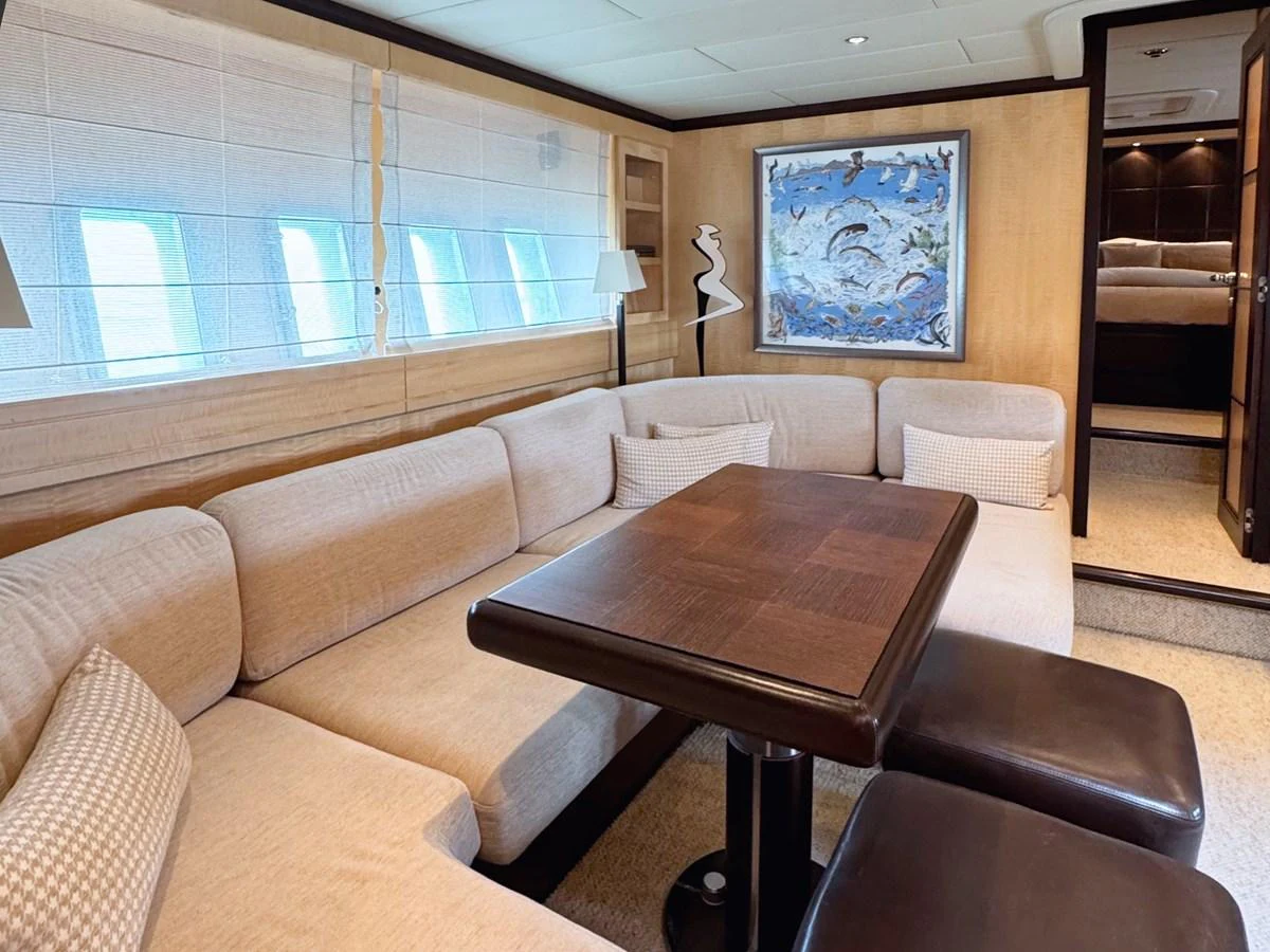The yacht's salon features a comfortable seating area with a stylish table and modern decor. aboard CARO Yacht for Sale