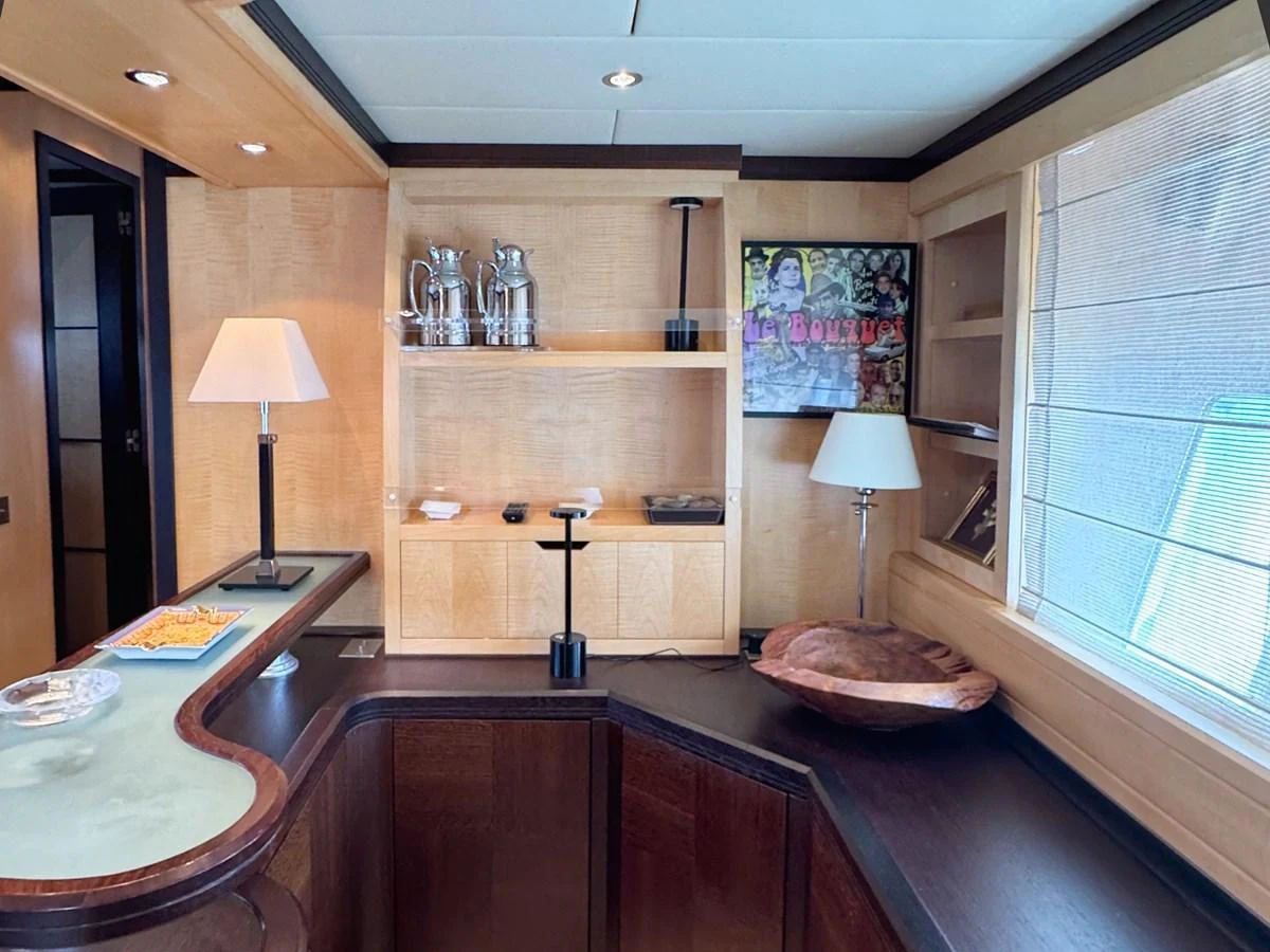 A sophisticated interior space featuring a bar area with elegant decor and ample natural light. aboard CARO Yacht for Sale