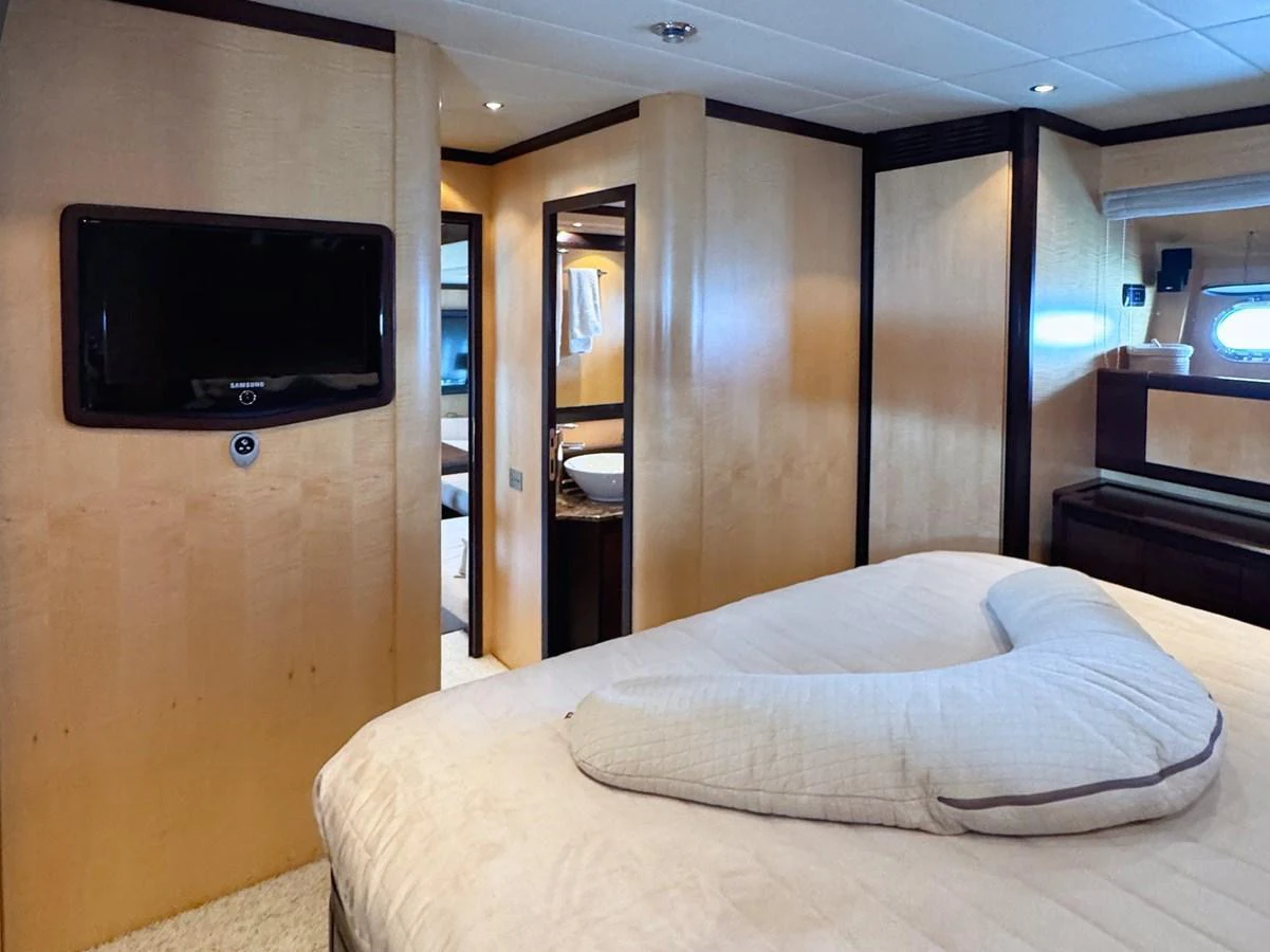 A cozy stateroom with a comfortable bed and modern amenities. aboard CARO Yacht for Sale