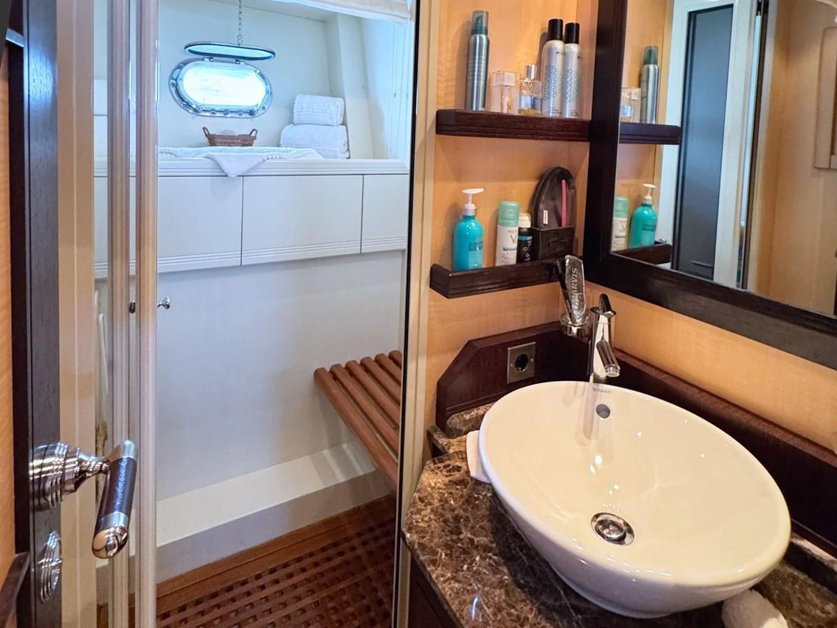 A stylish yacht bathroom featuring a modern sink and ample storage space. aboard CARO Yacht for Sale