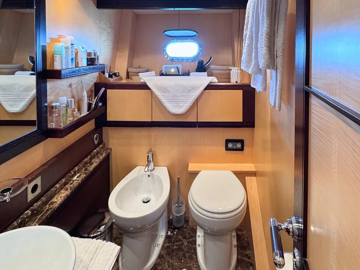 A well-appointed yacht bathroom featuring modern fixtures and ample storage. aboard CARO Yacht for Sale