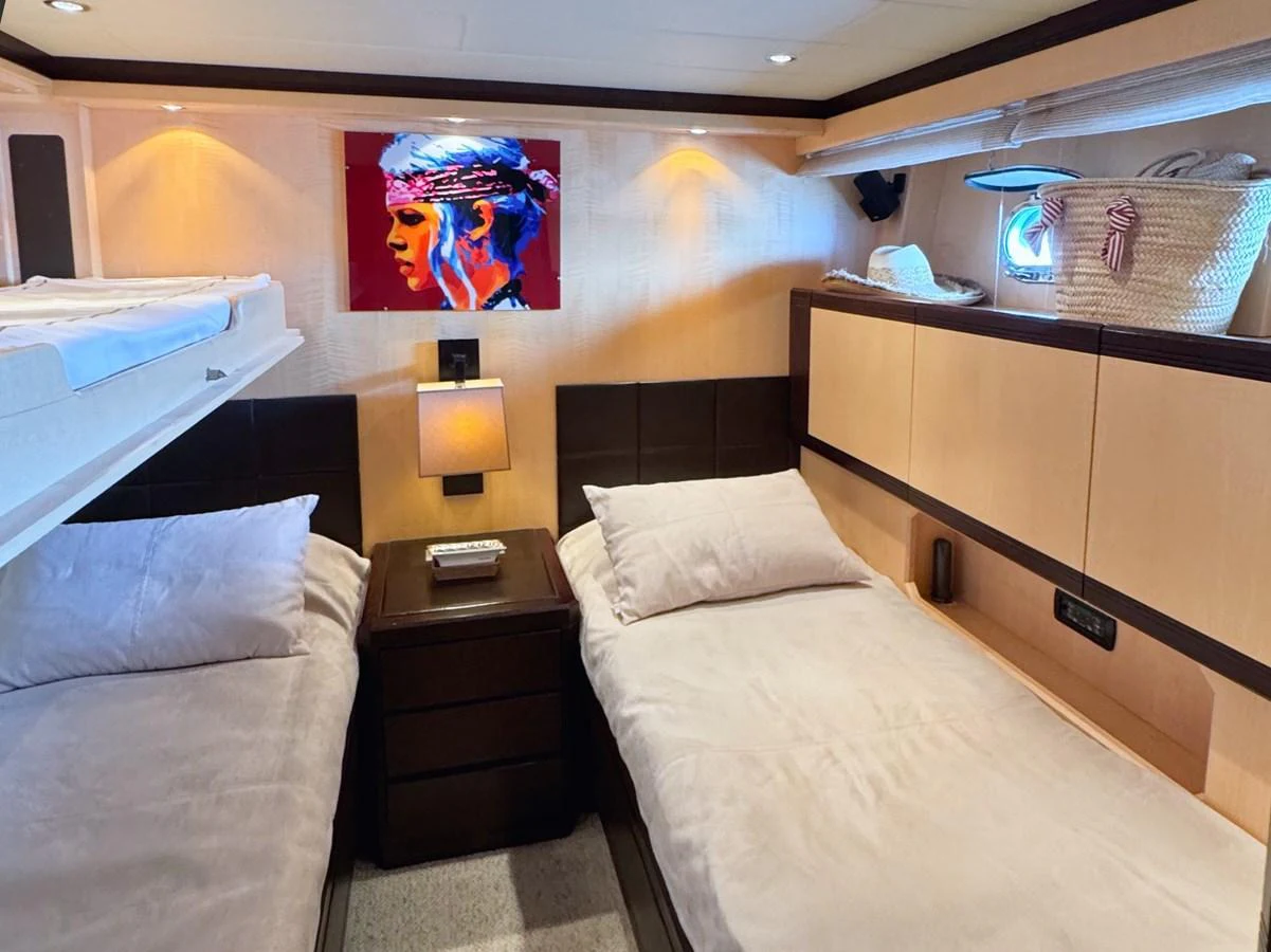 The twin stateroom offers a cozy and comfortable sleeping arrangement with two single beds and modern decor. aboard CARO Yacht for Sale