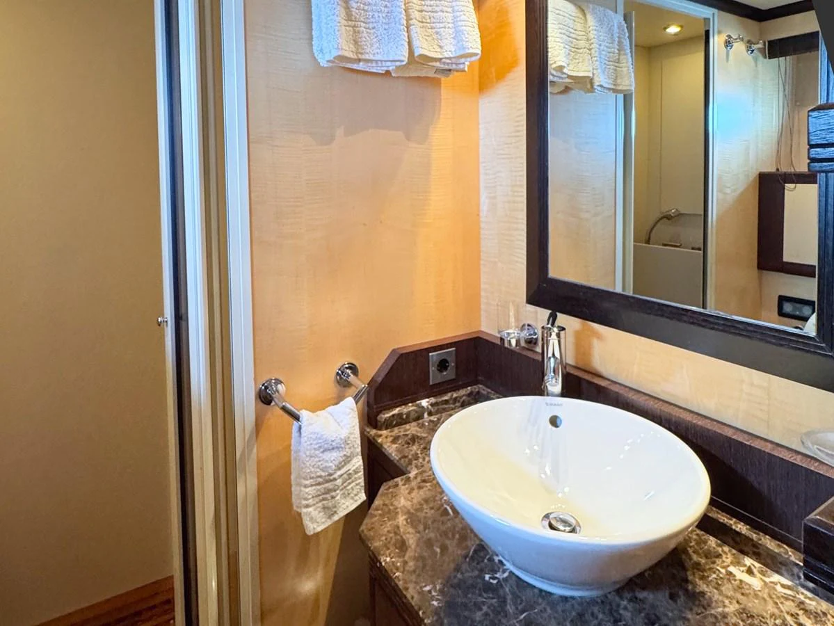 The yacht's bathroom features a modern sink and elegant marble countertop. aboard CARO Yacht for Sale