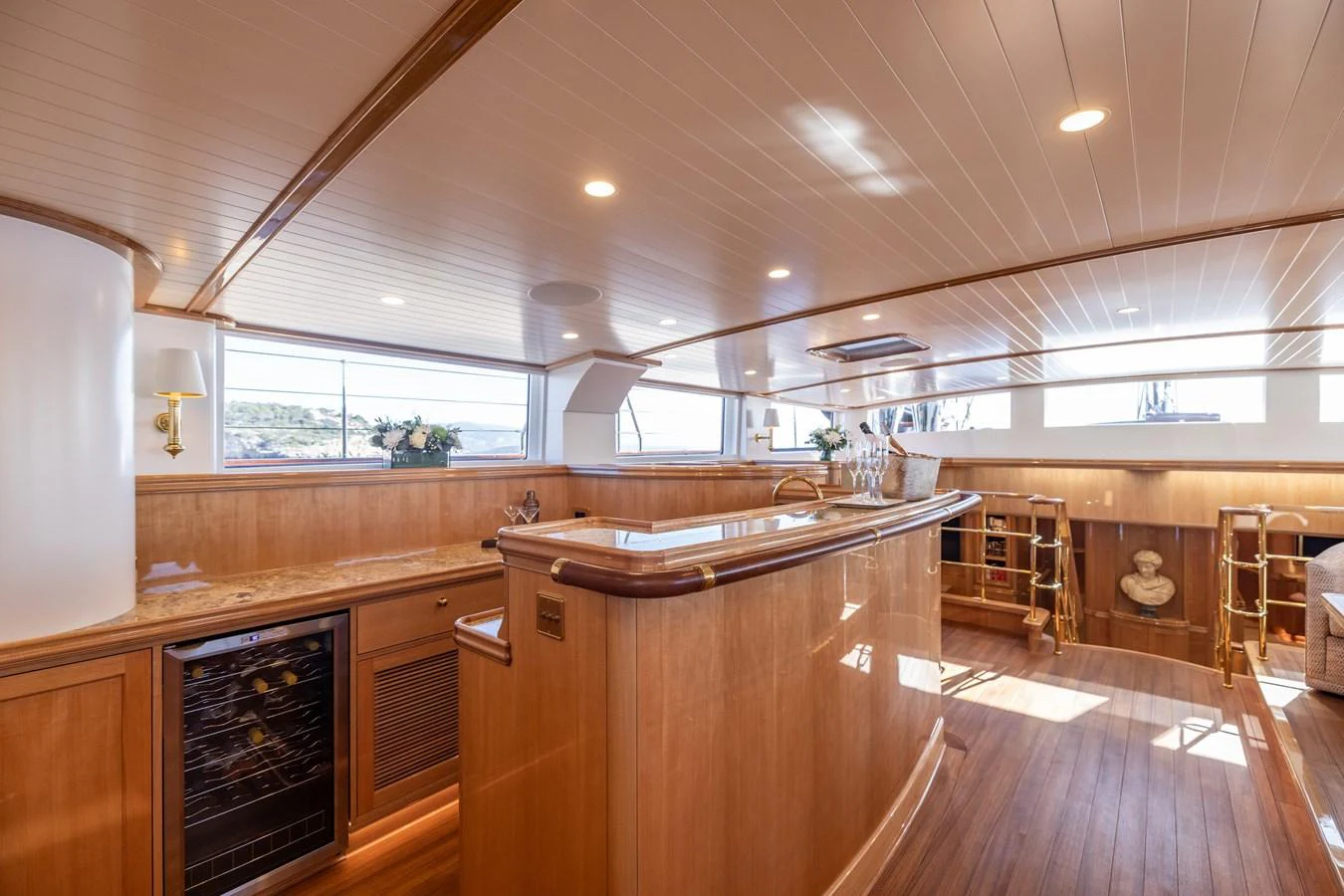 The yacht's galley features elegant wood finishes and ample natural light. aboard MAXIMUS Yacht for Sale