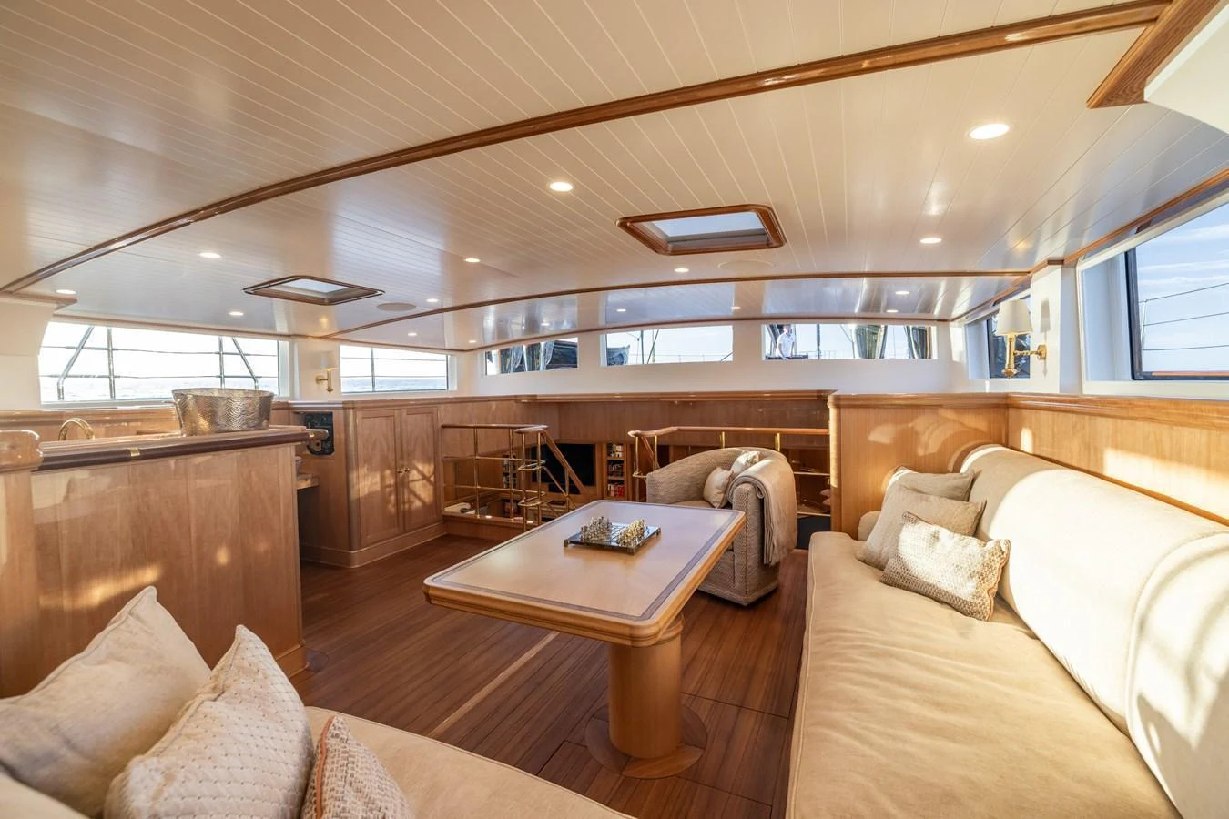 The salon features a spacious and inviting seating area with ample natural light. aboard MAXIMUS Yacht for Sale