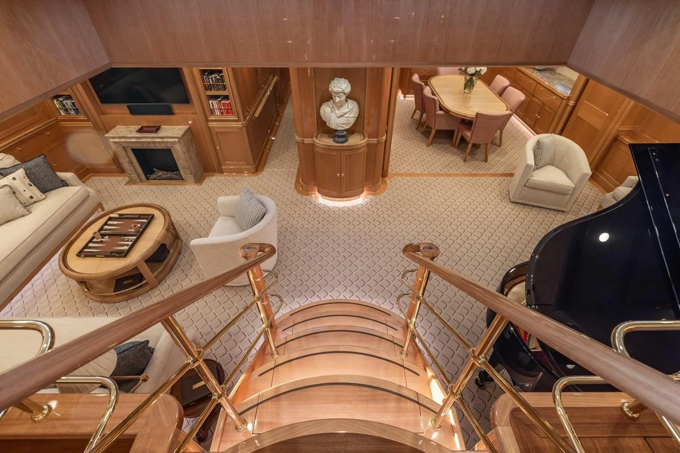 The luxurious salon features elegant furnishings, a grand piano, and a cozy fireplace, creating an inviting atmosphere for relaxation and entertainment. aboard MAXIMUS Yacht for Sale