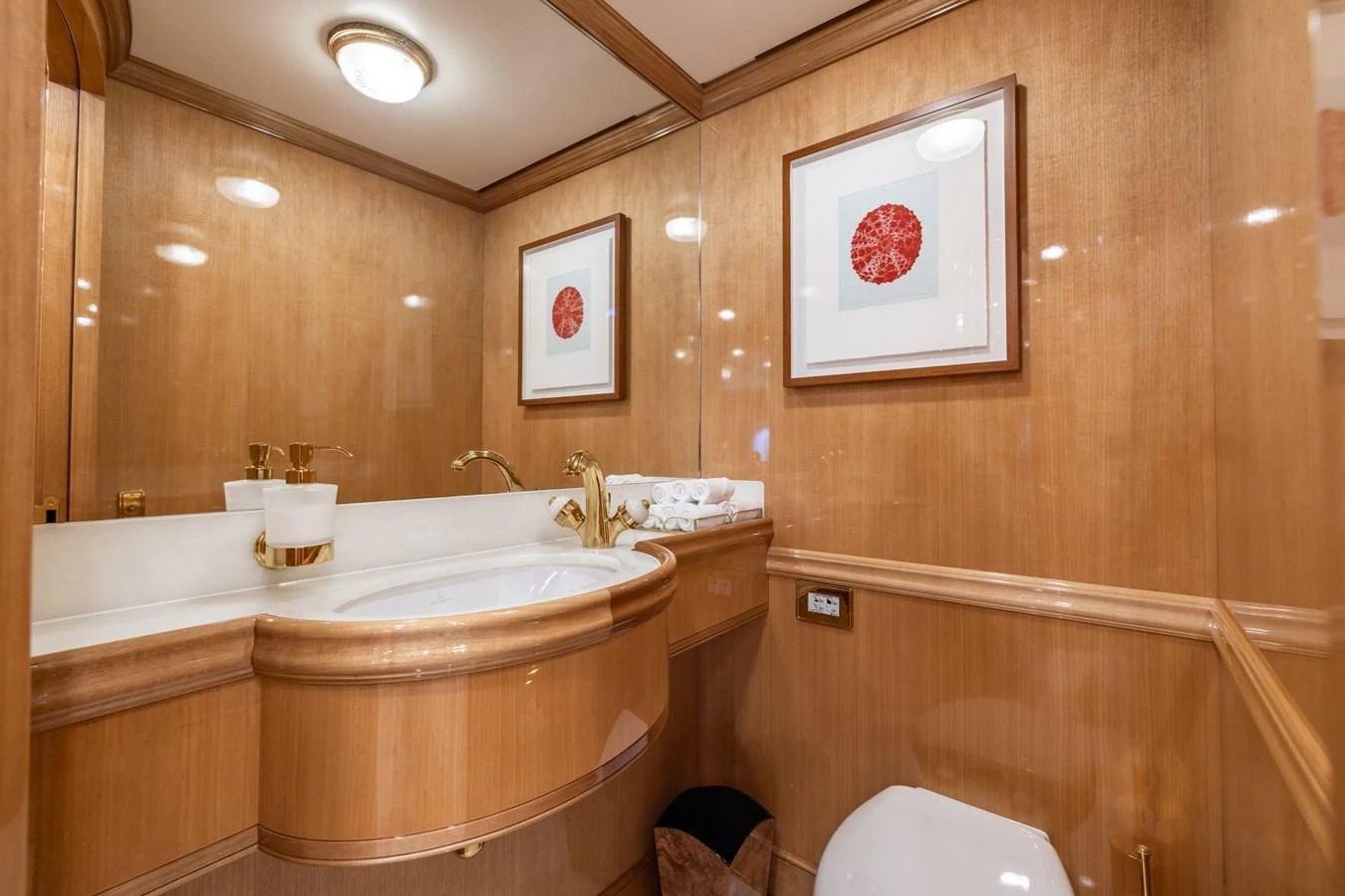 The yacht's bathroom features elegant wood paneling and luxurious fixtures. aboard MAXIMUS Yacht for Sale