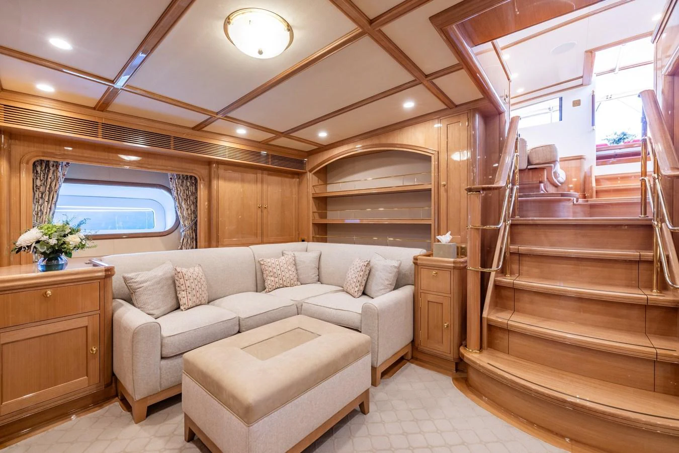 The salon features a cozy seating area with plush furnishings and elegant wooden accents. aboard MAXIMUS Yacht for Sale