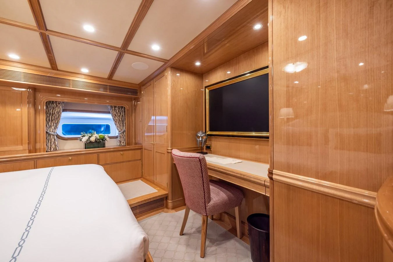 This elegant stateroom features warm wood paneling, a comfortable workspace, and a large window for natural light. aboard MAXIMUS Yacht for Sale