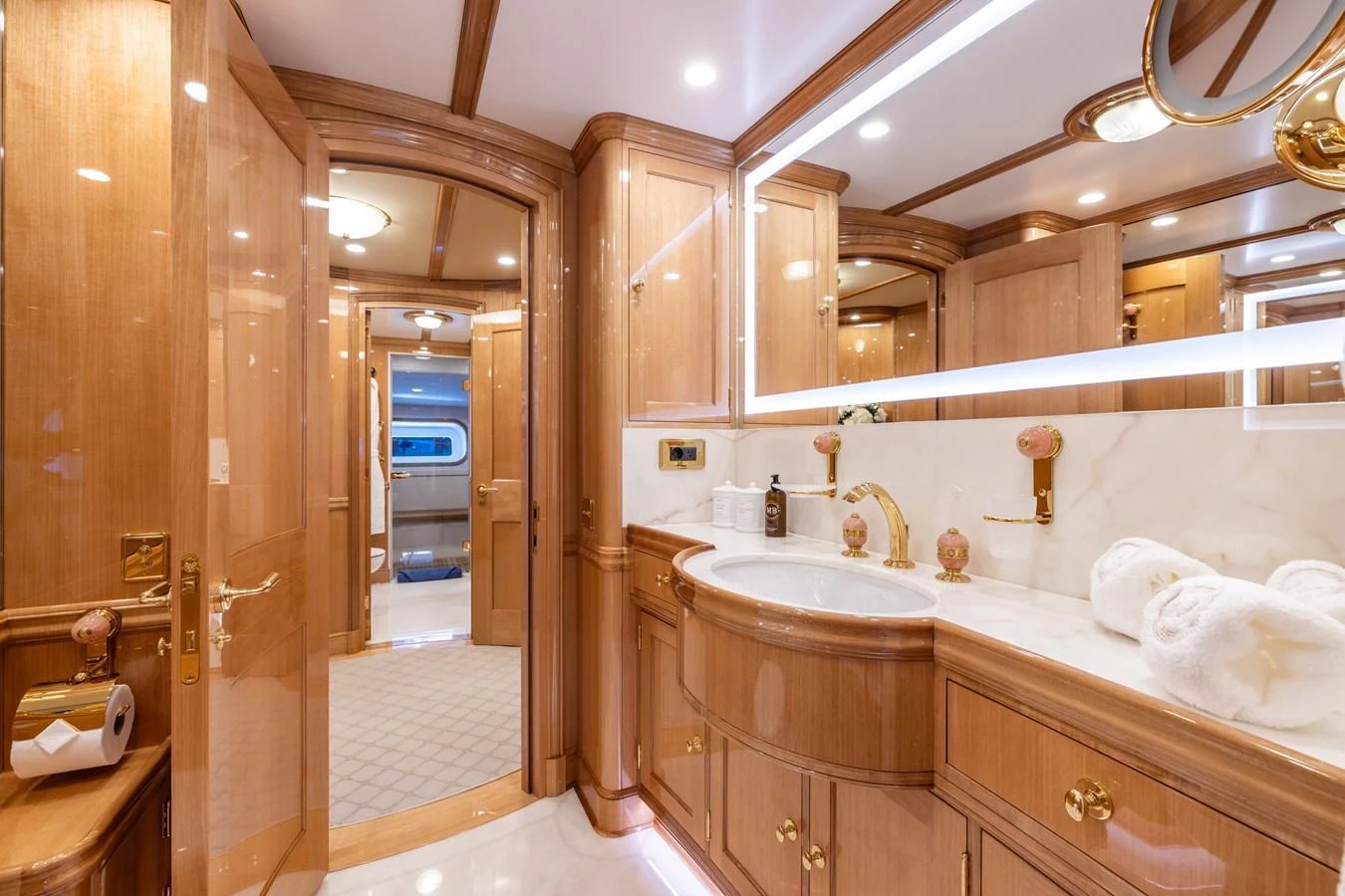 The yacht's bathroom features luxurious wood finishes and elegant fixtures. aboard MAXIMUS Yacht for Sale
