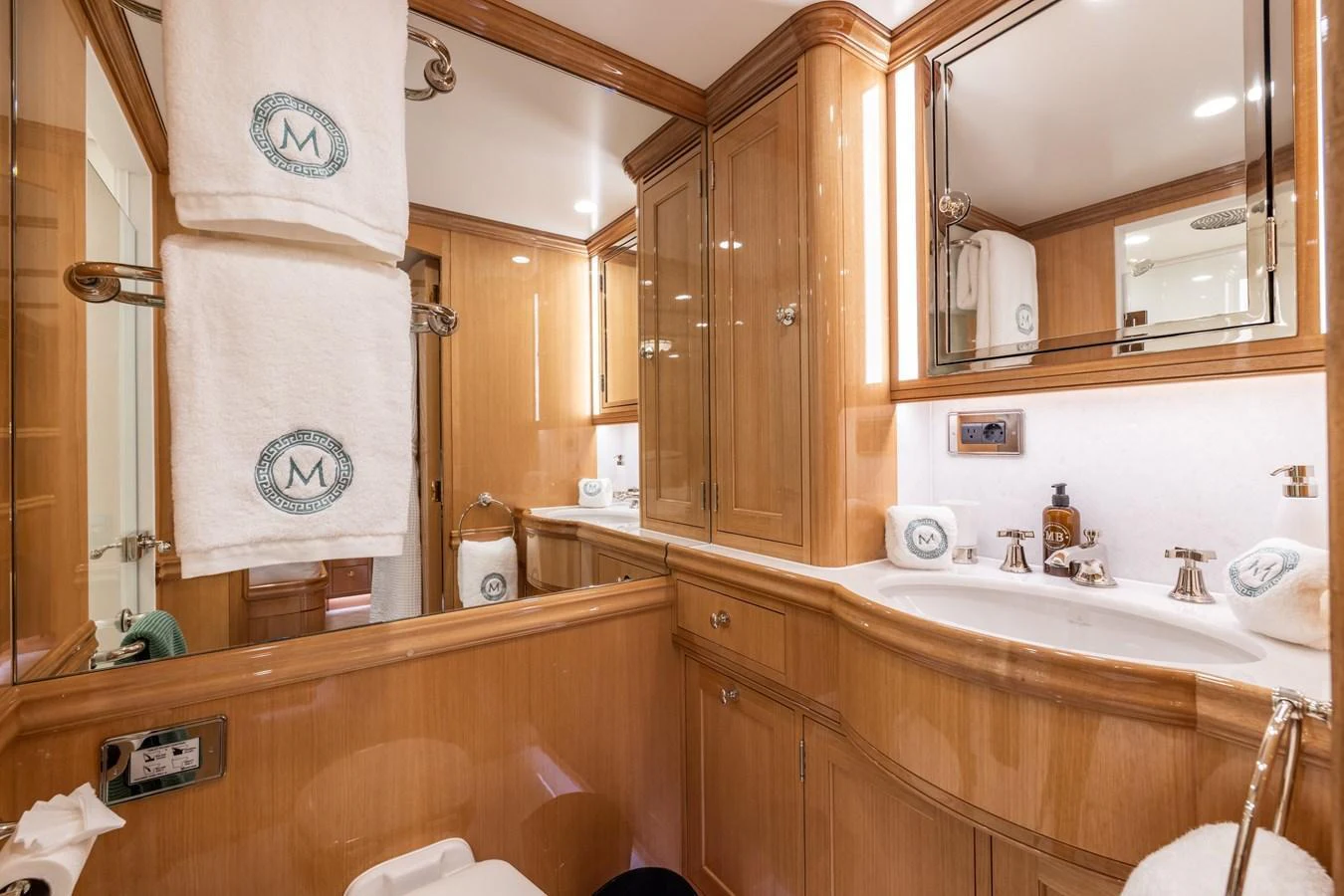 A luxurious yacht bathroom featuring elegant wood cabinetry and modern fixtures. aboard MAXIMUS Yacht for Sale