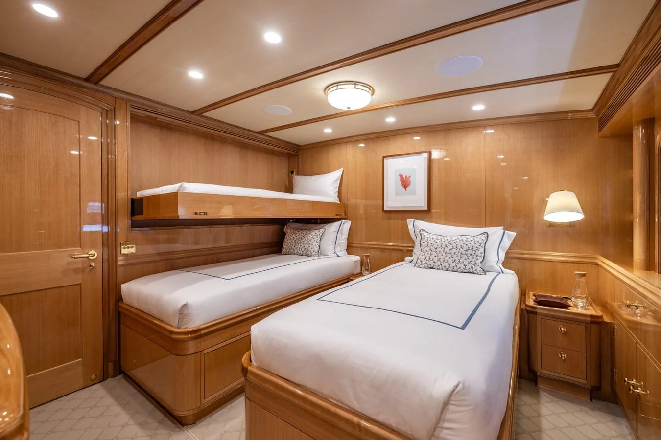 The guest stateroom features twin beds with luxurious bedding and warm wood paneling. aboard MAXIMUS Yacht for Sale