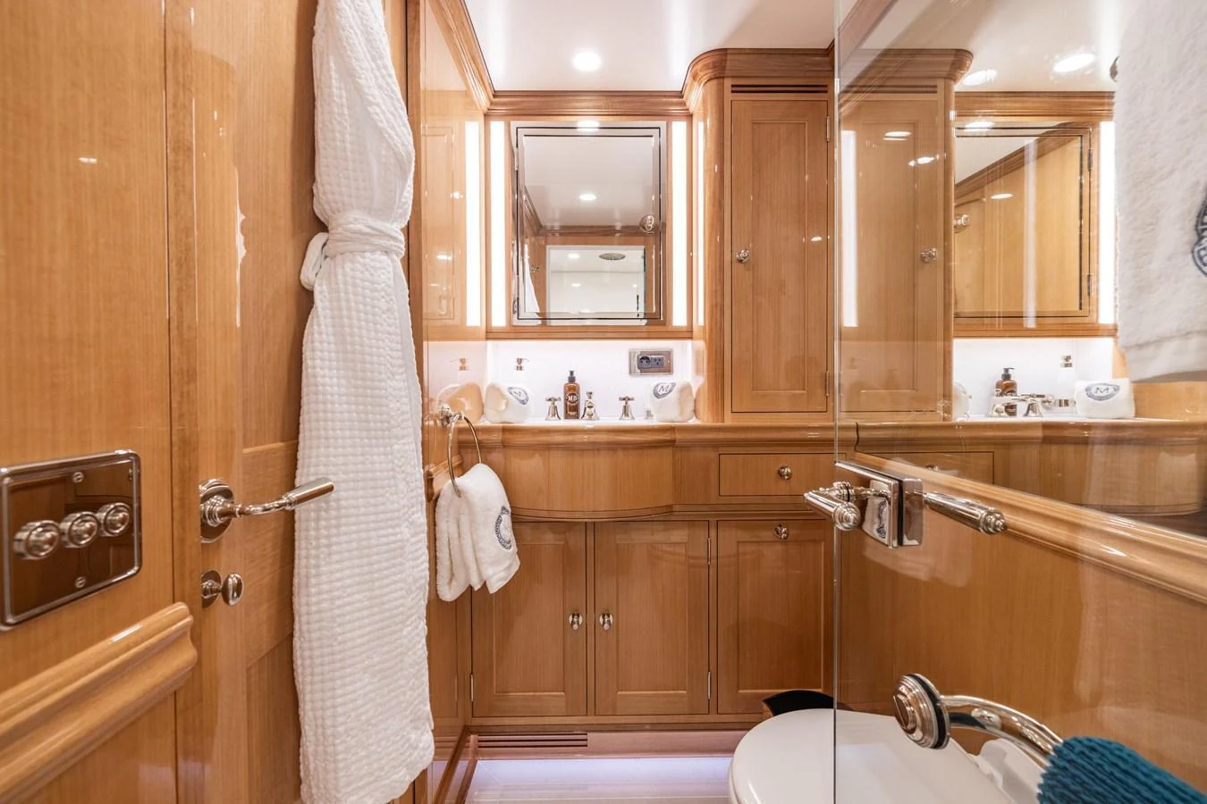 The yacht's bathroom features elegant wooden cabinetry and modern fixtures. aboard MAXIMUS Yacht for Sale