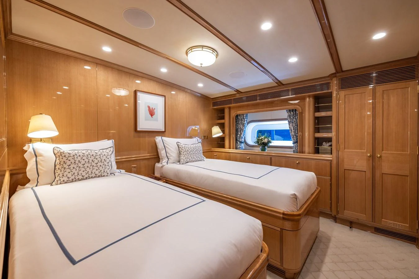 The guest stateroom features twin beds with elegant bedding and warm wooden finishes. aboard MAXIMUS Yacht for Sale