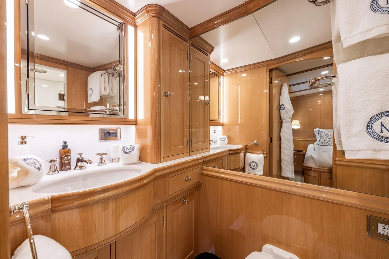 The yacht's bathroom features elegant wooden cabinetry and modern fixtures, creating a luxurious and inviting space. aboard MAXIMUS Yacht for Sale