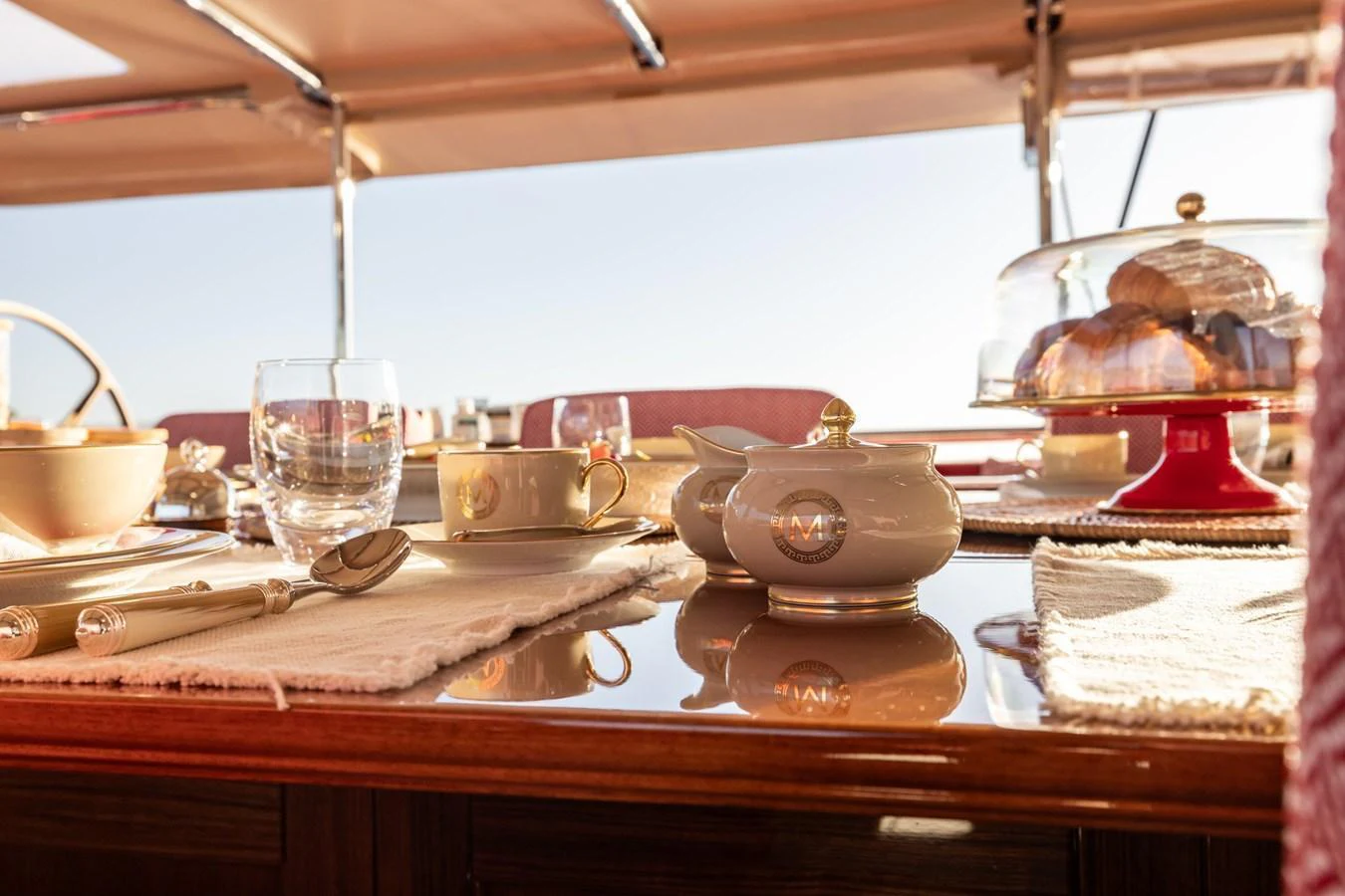 A beautifully set dining area on the yacht, featuring elegant tableware and a serene outdoor view. aboard MAXIMUS Yacht for Sale
