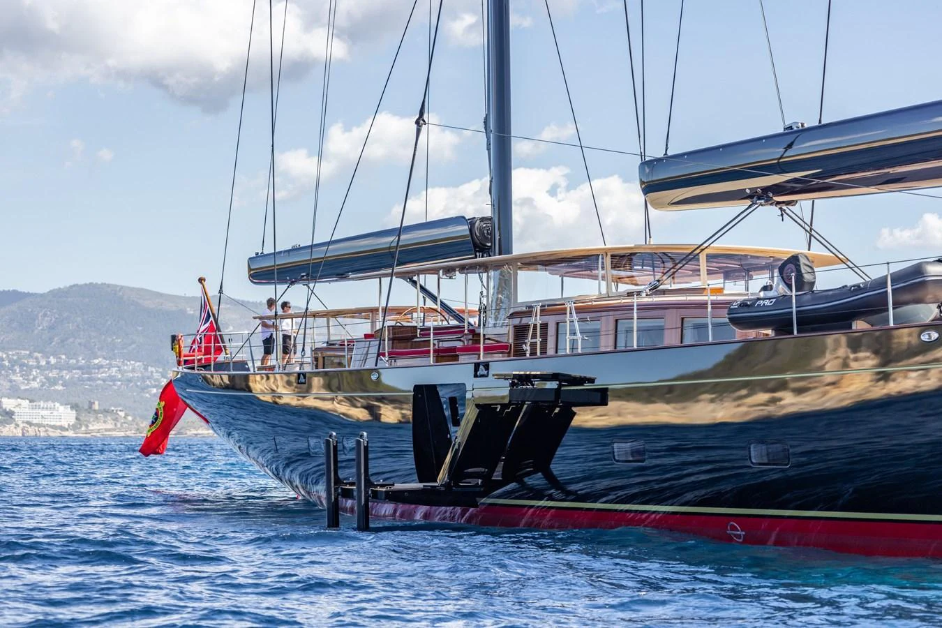A sleek yacht with a polished hull and modern design cruising on calm waters. aboard MAXIMUS Yacht for Sale