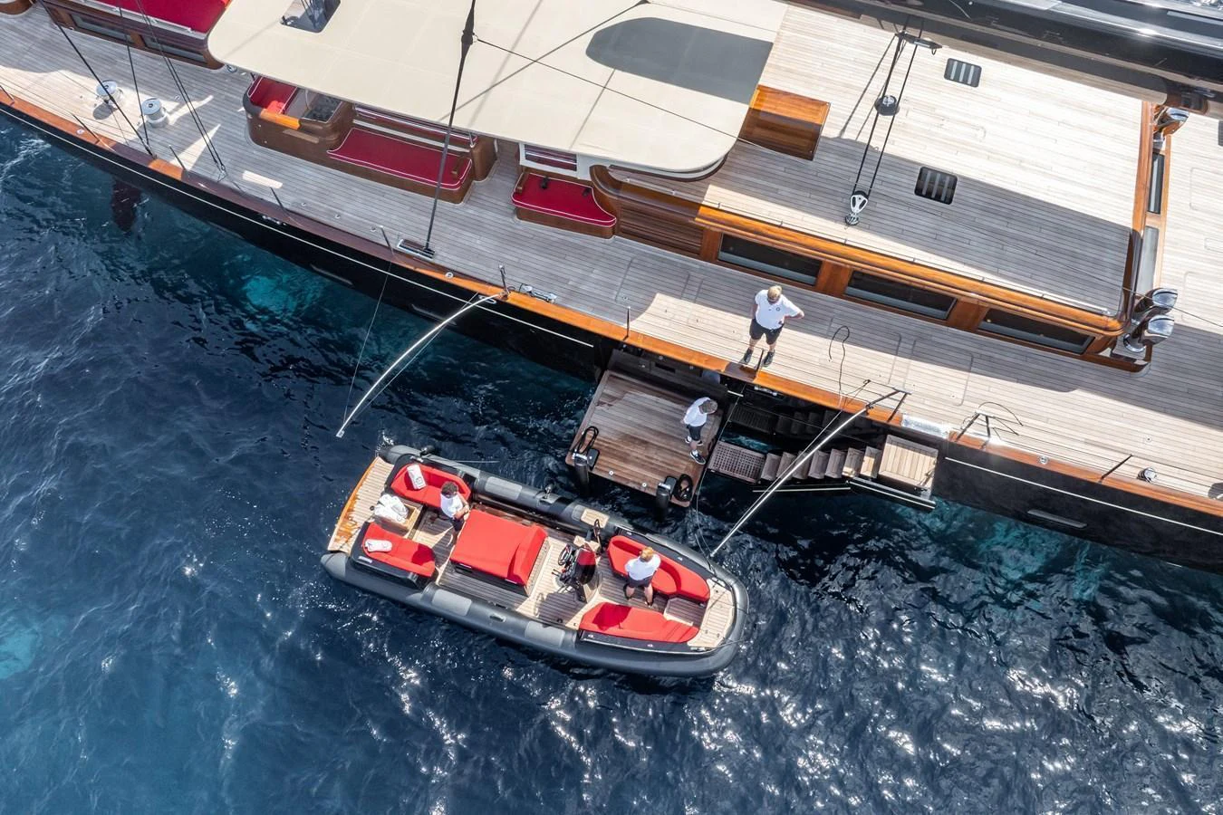 A tender is docked alongside the yacht, ready for passengers to board. aboard MAXIMUS Yacht for Sale