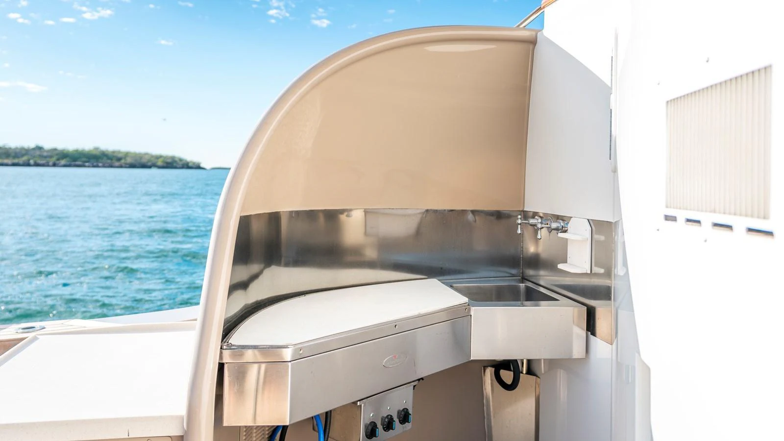 The yacht features a sleek outdoor galley with a stainless steel sink and countertop, perfect for alfresco dining. aboard TEXAS T Yacht for Sale