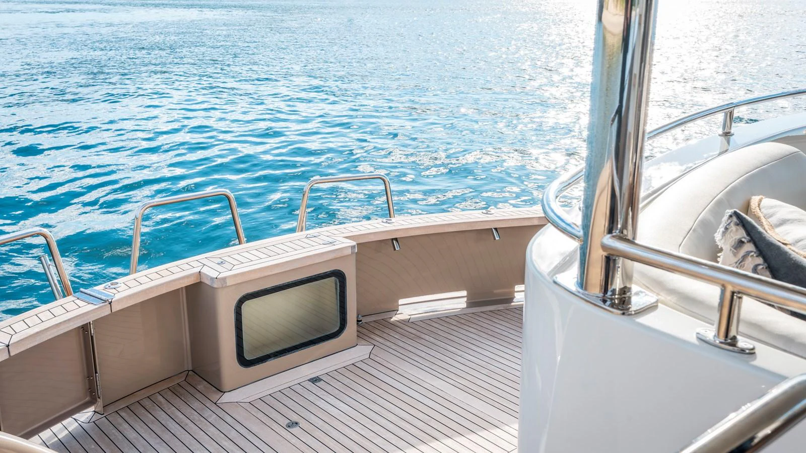 The yacht's aft deck offers a serene view of the water, complemented by sleek railings and a spacious layout. aboard TEXAS T Yacht for Sale