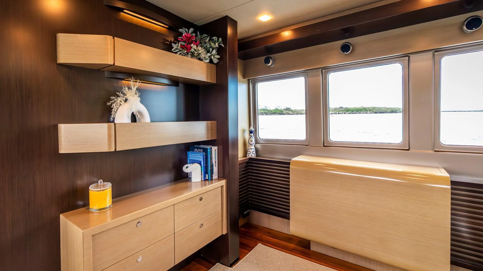 The yacht's interior features a stylish and modern design with ample natural light from large windows. aboard TEXAS T Yacht for Sale