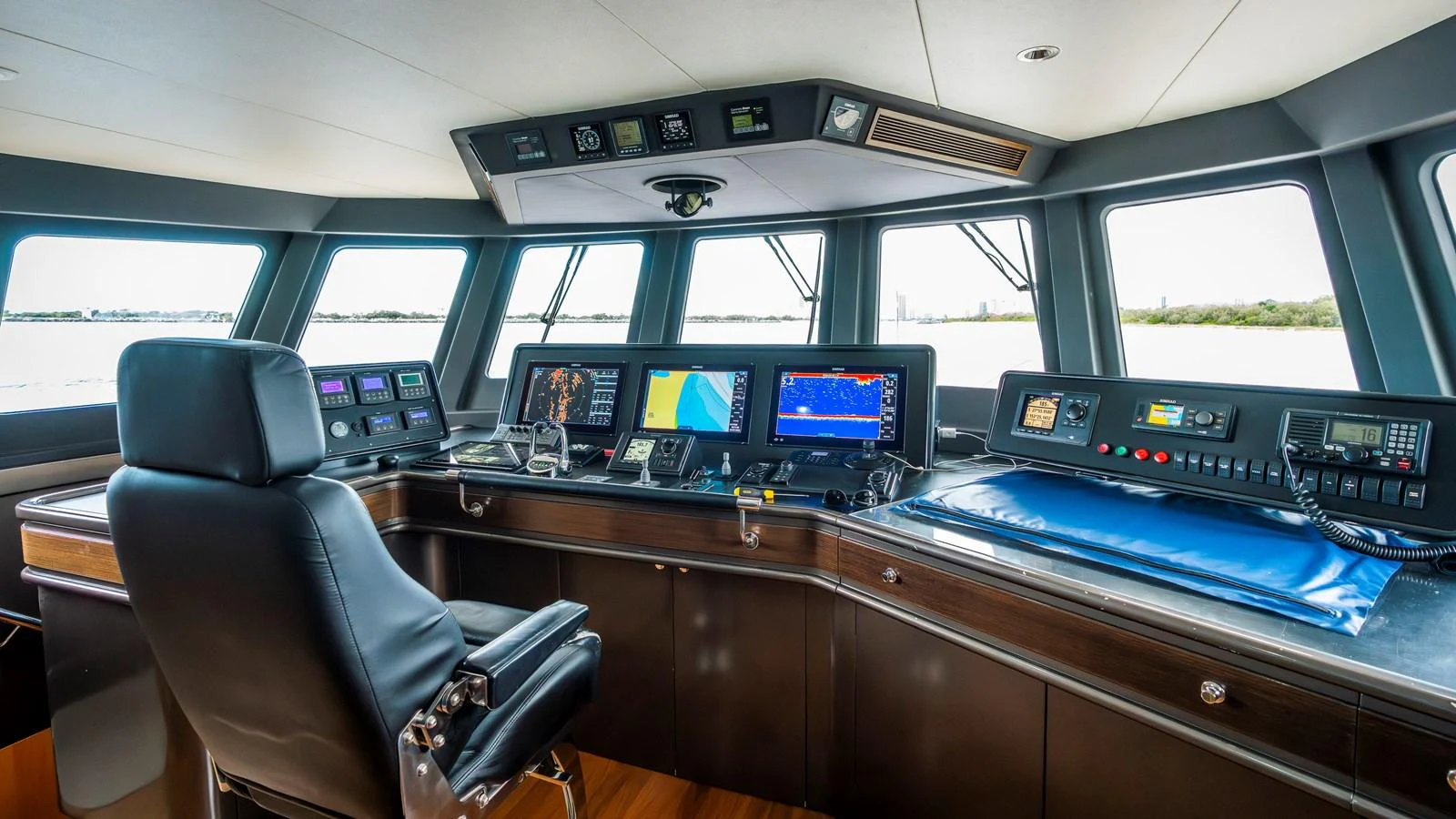 The helm station features advanced navigation equipment and a comfortable captain's chair, offering a commanding view of the surroundings. aboard TEXAS T Yacht for Sale