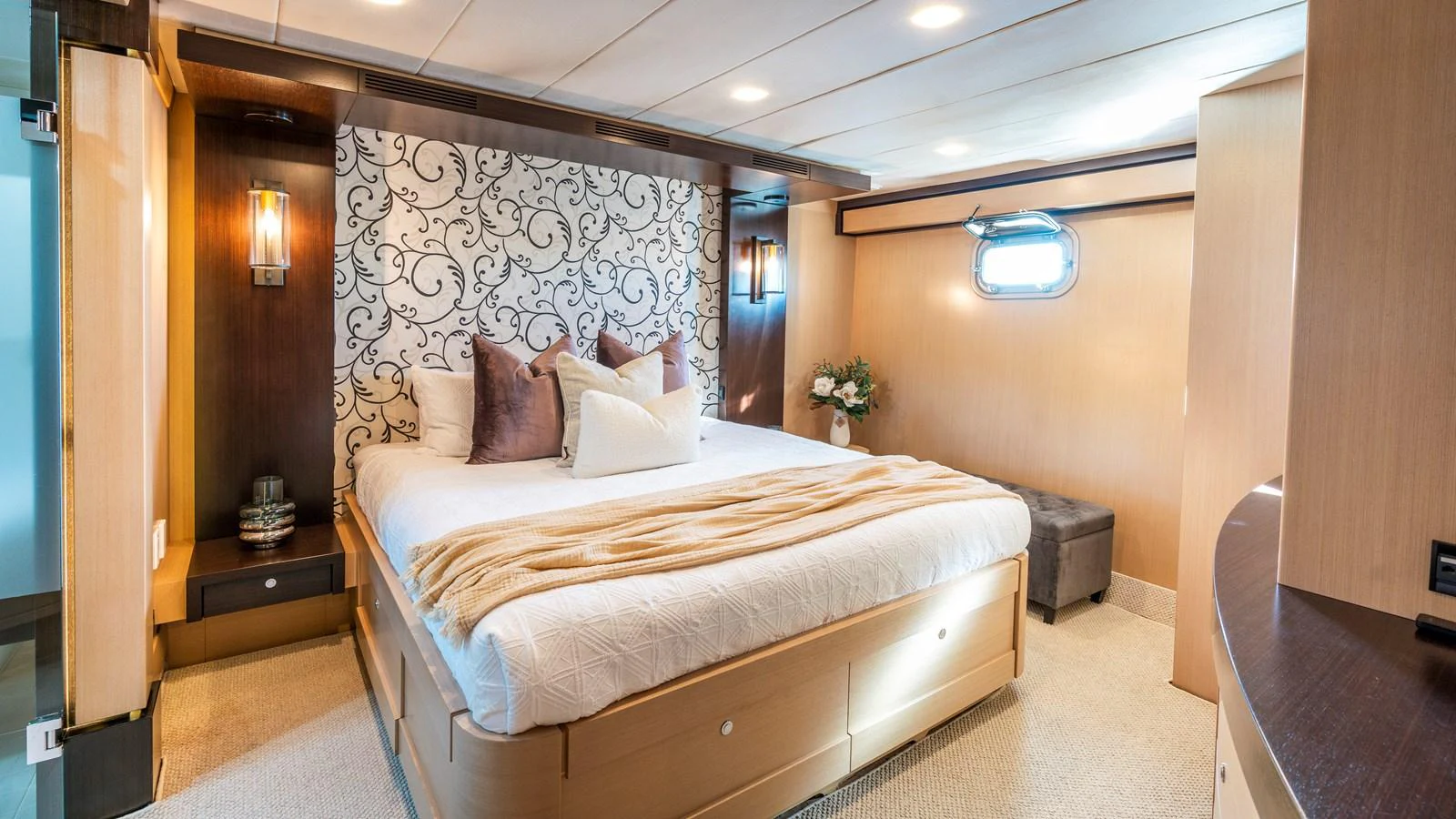 The master stateroom features a luxurious bed with elegant decor and ample natural light. aboard TEXAS T Yacht for Sale