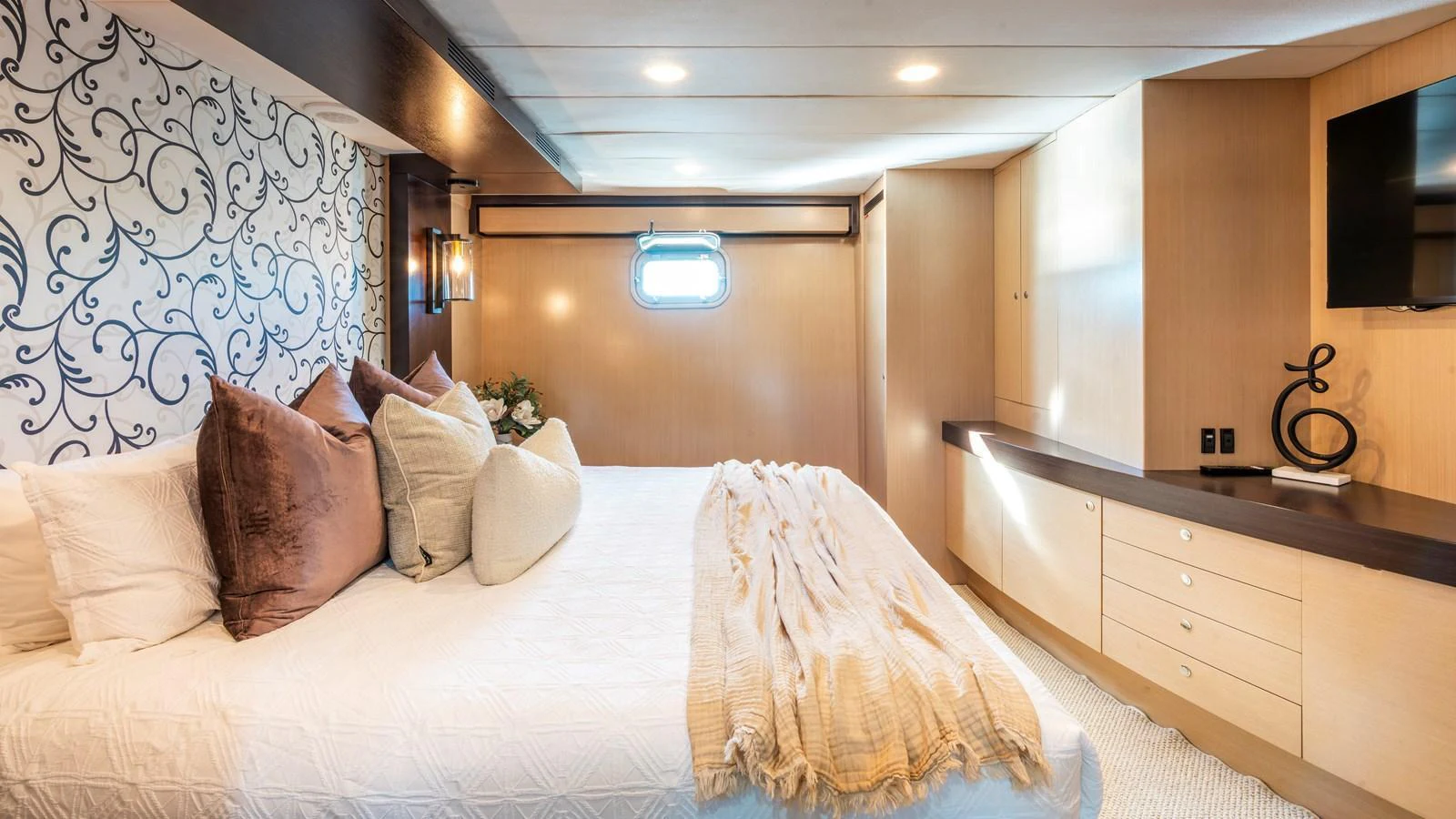 The master stateroom features a luxurious bed with elegant decor and ample storage space. aboard TEXAS T Yacht for Sale