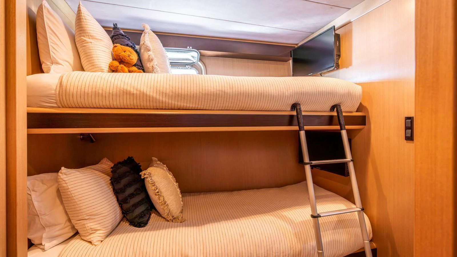The cozy bunk cabin features comfortable bedding and a warm, inviting atmosphere. aboard TEXAS T Yacht for Sale