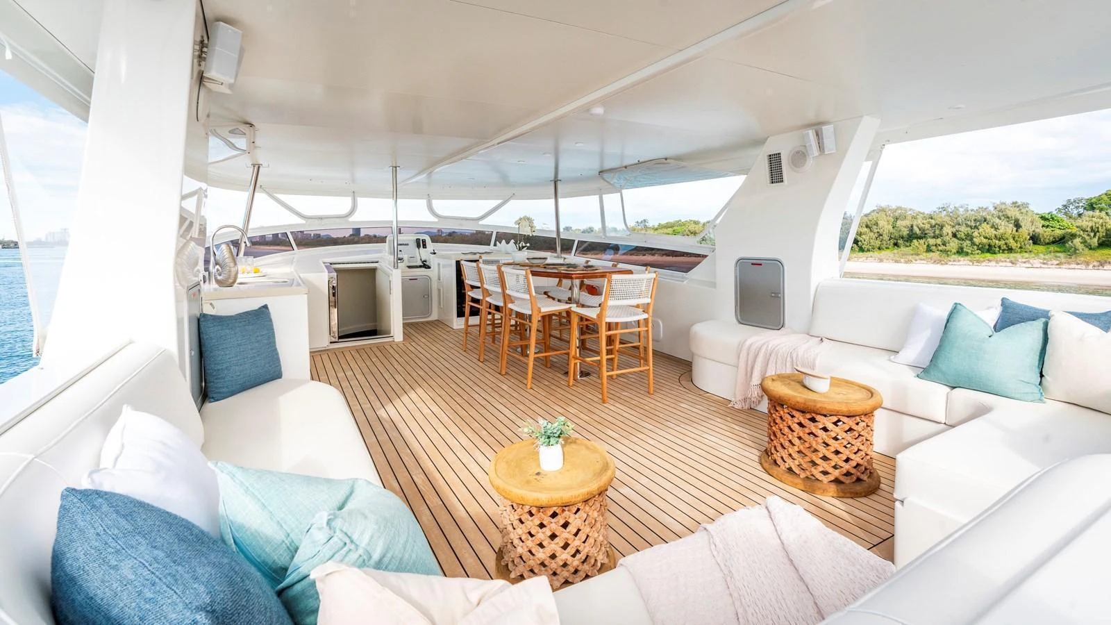 The aft deck features a spacious and inviting seating area with plush cushions and stylish wooden tables, perfect for relaxation and dining. aboard TEXAS T Yacht for Sale