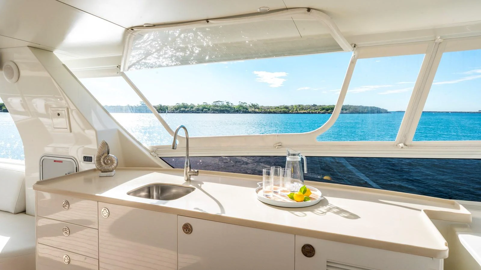 The galley offers a bright and inviting space with a stunning view of the water. aboard TEXAS T Yacht for Sale