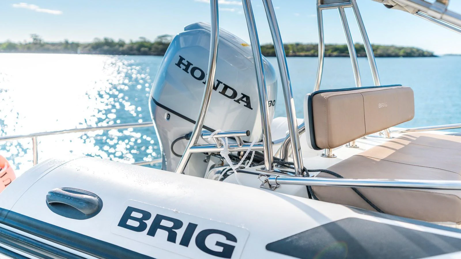 The image showcases the engine and seating area of a yacht, highlighting the Honda motor and Brig branding. aboard TEXAS T Yacht for Sale