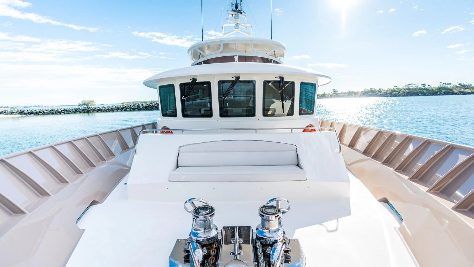 The yacht's aft deck offers a spacious and inviting area with a comfortable seating arrangement and polished winches. aboard TEXAS T Yacht for Sale