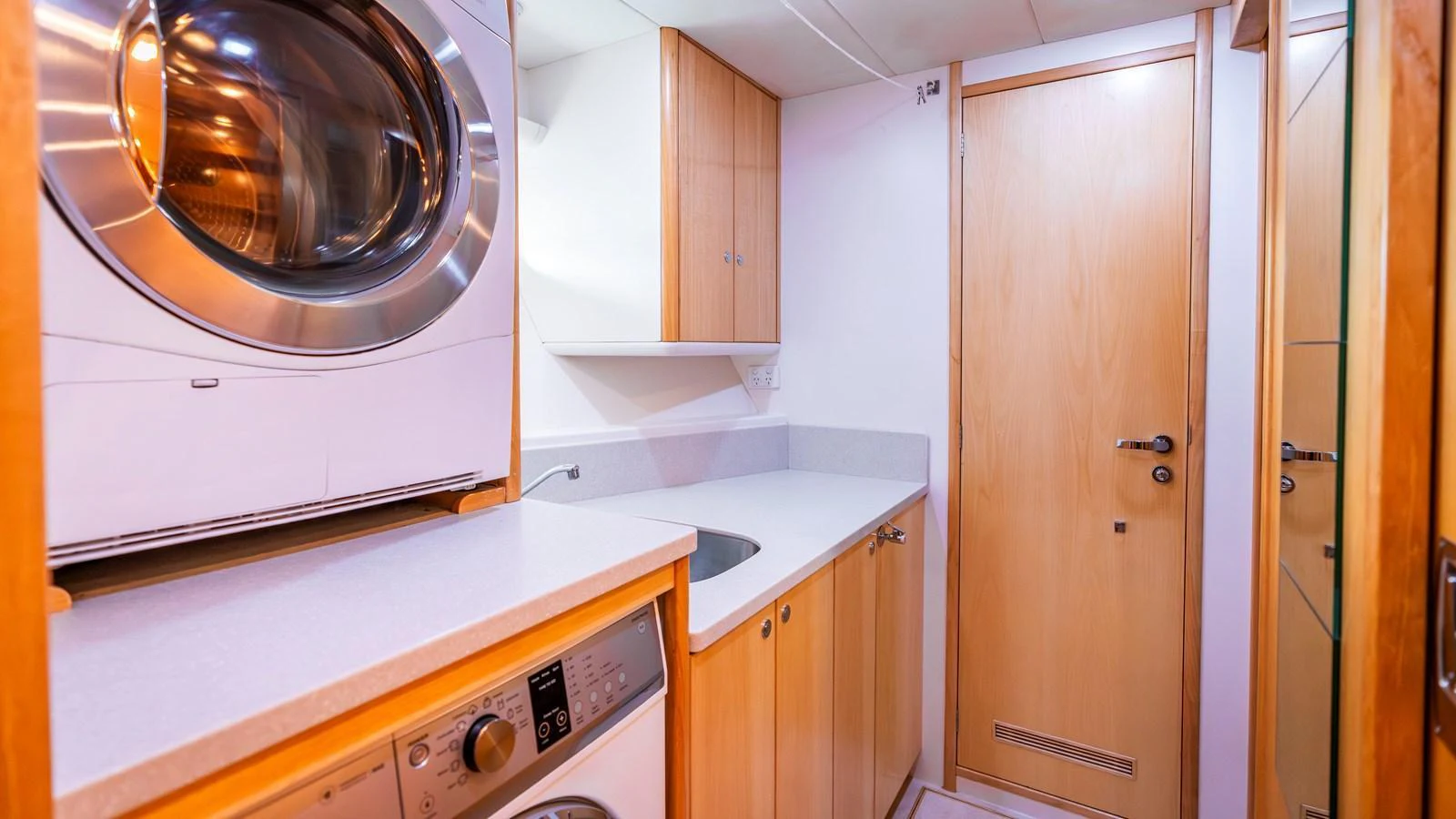 The yacht features a well-equipped laundry room with modern appliances and ample storage. aboard TEXAS T Yacht for Sale