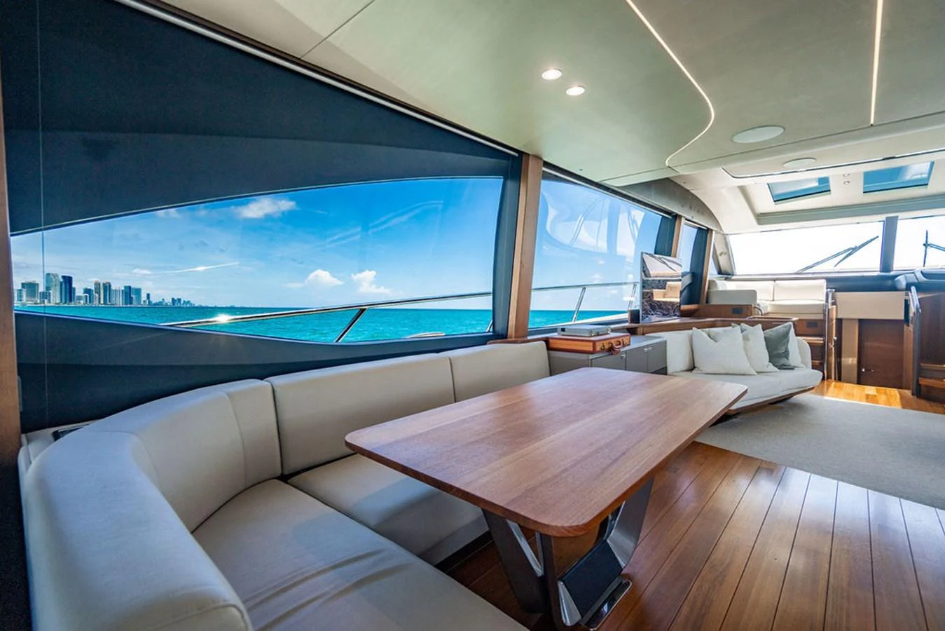 a living room with a large screen aboard COCOON Yacht for Sale