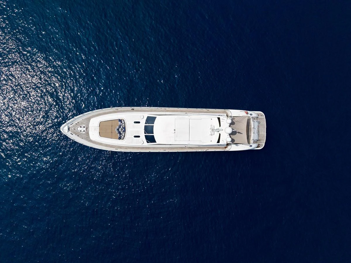 Aerial view of a sleek yacht cruising through deep blue waters. aboard CHEEKY TIGER Yacht for Sale