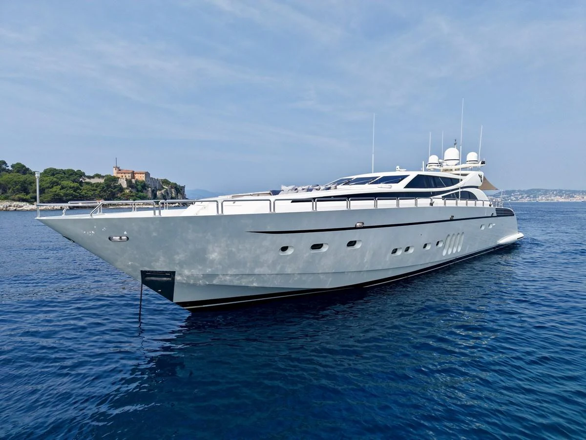 A sleek and modern yacht glides gracefully on calm waters under a clear sky. aboard CHEEKY TIGER Yacht for Sale