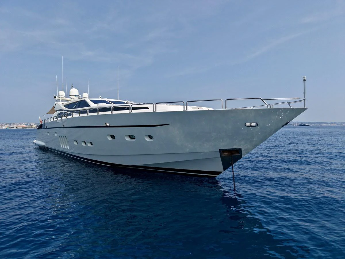 A sleek and modern yacht glides gracefully on calm blue waters under a clear sky. aboard CHEEKY TIGER Yacht for Sale
