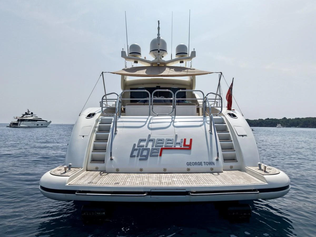 The yacht's aft deck features a spacious swim platform and sleek design, perfect for enjoying the water. aboard CHEEKY TIGER Yacht for Sale