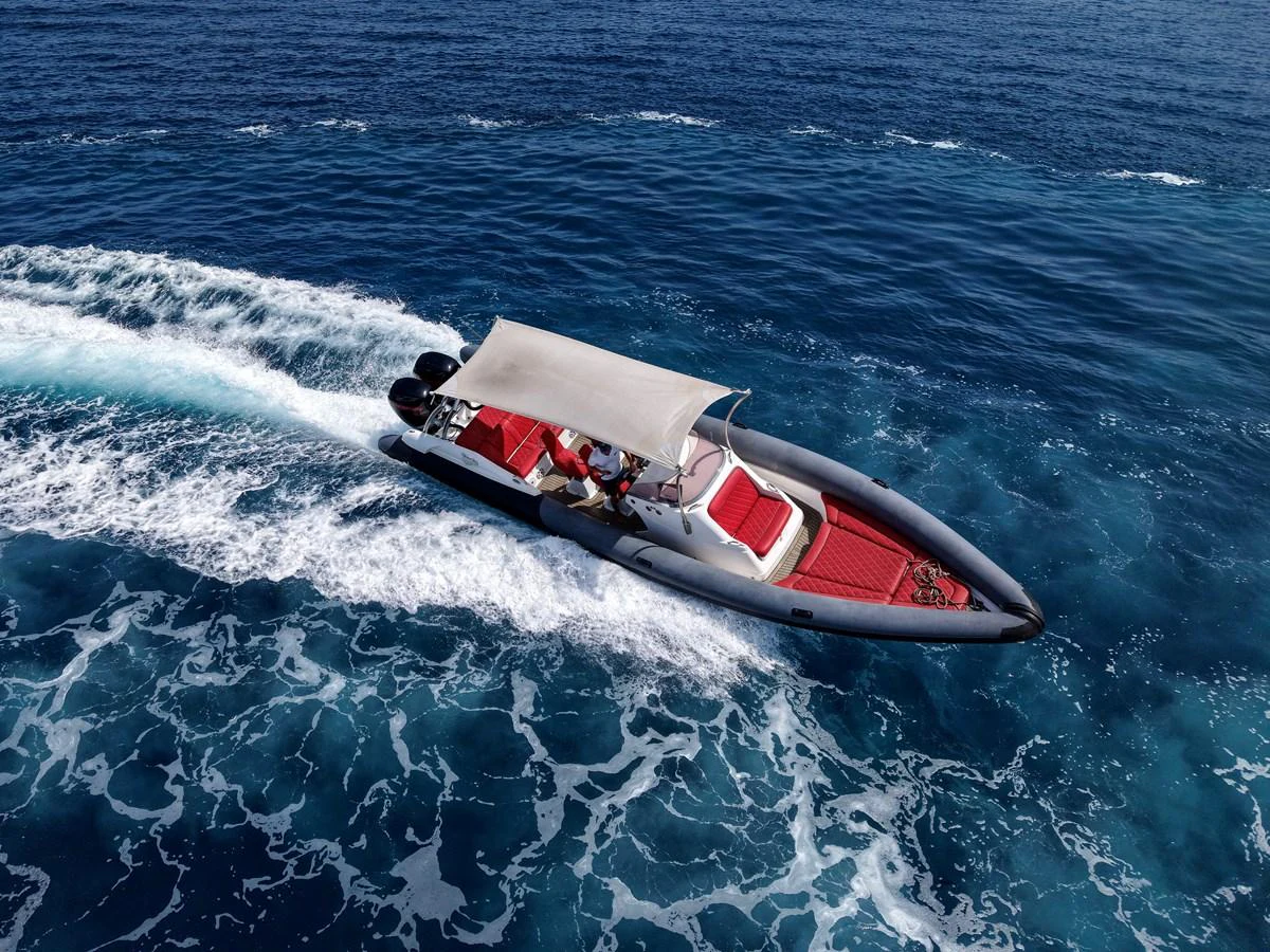 A sleek tender with a canopy cruises swiftly over the open water. aboard CHEEKY TIGER Yacht for Sale